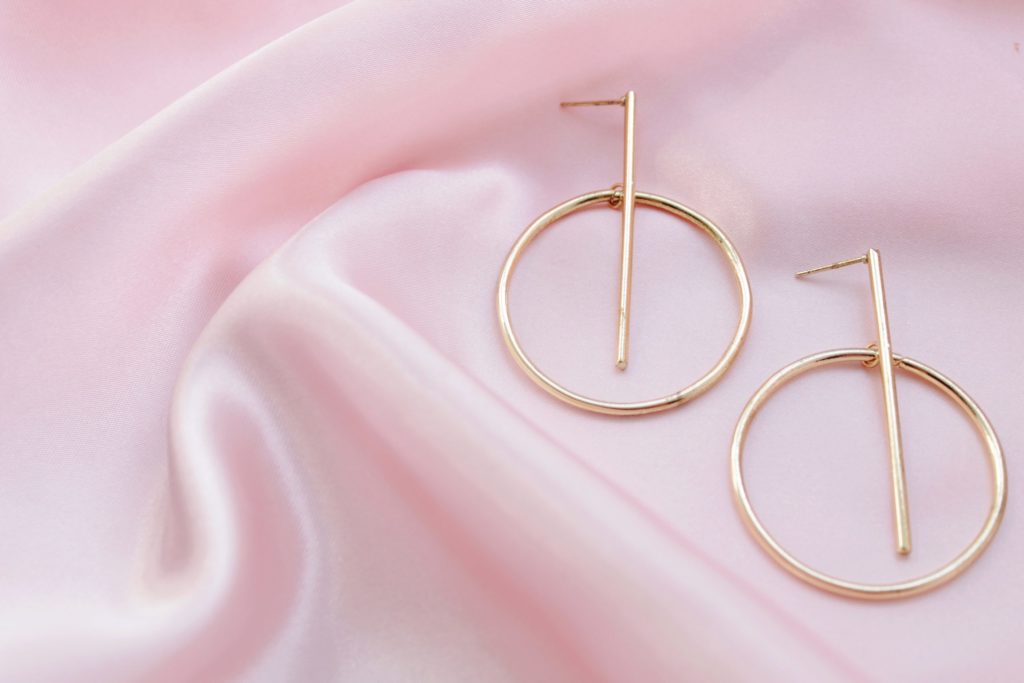 gold hoop earrings on pink fabric 2021 11 04 21 10 06 utc scaled