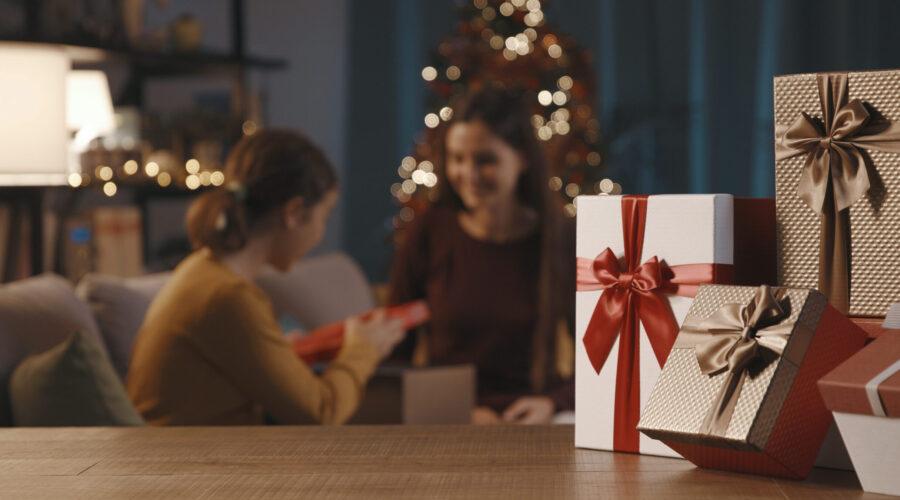 mother and daughter exchanging christmas gifts 2022 01 19 00 21 44 utc scaled